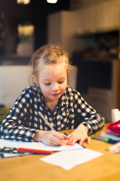 istock girl is doing schoolwork at home 911999952
