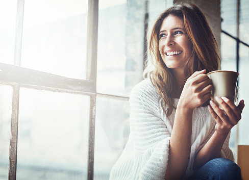 Shot of an attractive young woman relaxing at home