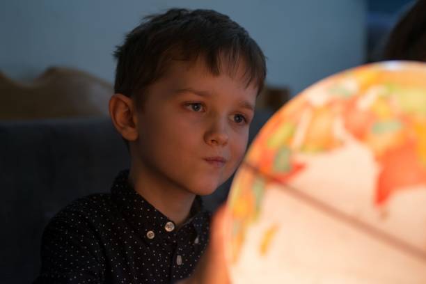 istock Little fascinated boy is planning another trip 912000070