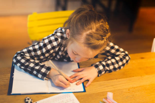 istock girl is doing schoolwork at home 912000368
