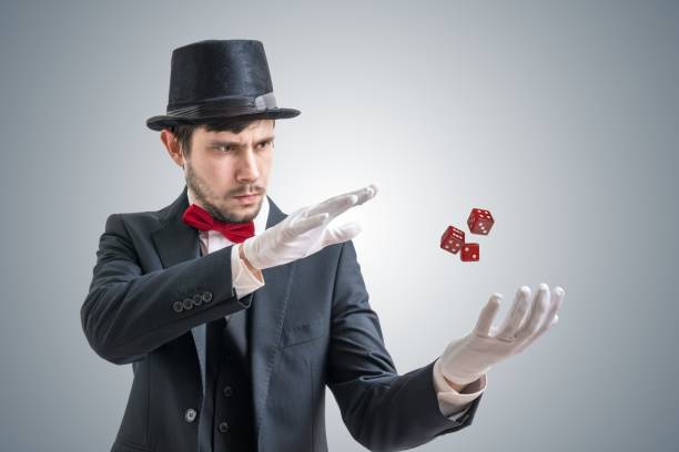 istock Young illusionist or magician is showing magic trick with levitating dice. 912000892