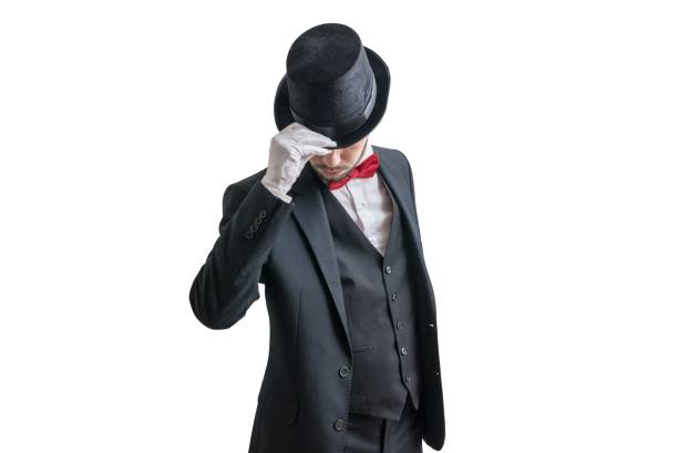 Gallant magician or illusionist in suit is taking off his hat. Isolated on white background. Gallant magician or illusionist in suit is taking off his hat. Isolated on white background. chivalry stock pictures, royalty-free photos & images