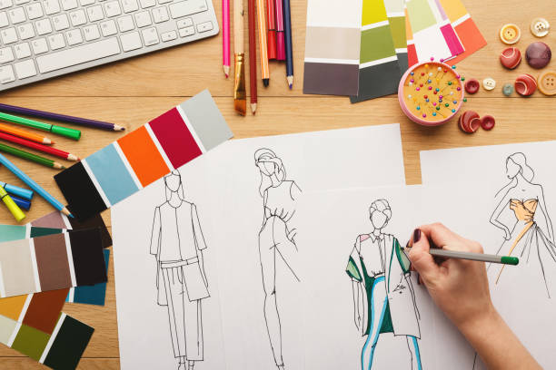 istock Top view on woman designer drawing clothes sketches 912003748