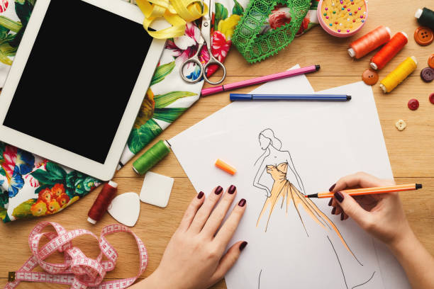 istock Top view on woman designer drawing clothes sketches 912003864
