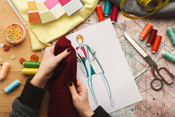 istock Female fashion designer working with fabric sample and drawn illustration 912003964