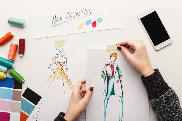 istock Top view on woman designer drawing clothes sketches 912004138