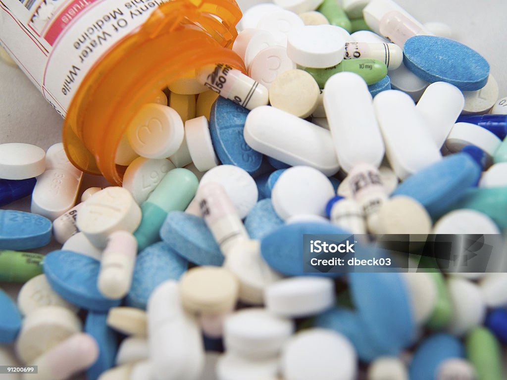 Pills and container  Capsule - Medicine Stock Photo