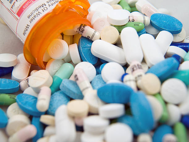 Pills and container stock photo