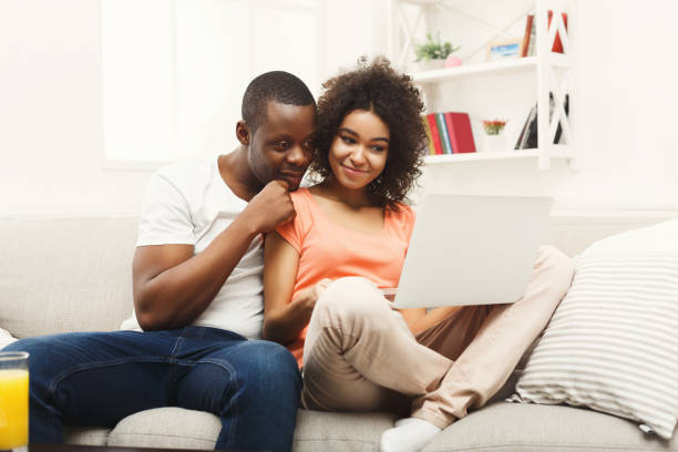 istock Young african-american couple working on laptop, copy space 912007970
