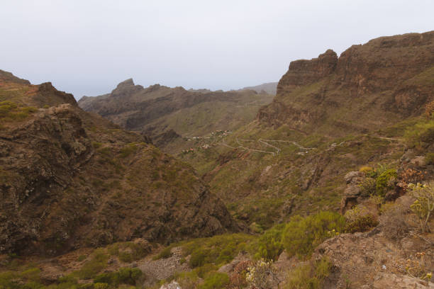 istock Road in rocky landscape with steep cliffs 912011064