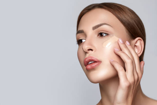 Woman applying foundation. Skin tone cream lines on woman face. Beautiful woman portrait beauty skin healthy and perfect makeup. Space for text. beauty woman portrait with fresh natural skin, beauty and spa concept foundation make up stock pictures, royalty-free photos & images