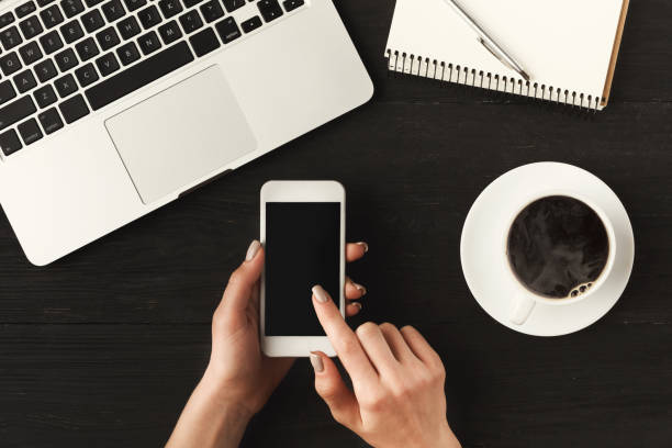 istock Woman's hands holding a smartphone, top view 912014640