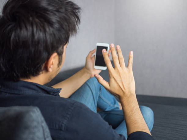 istock Man holding phone, waving at the phone, making video call 912015648