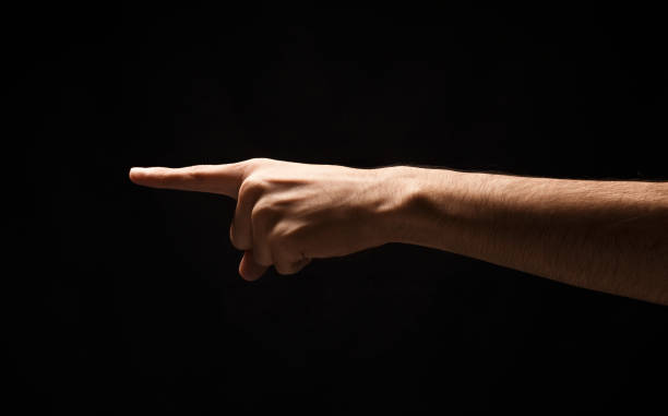 istock Hand gestures - man pointing, isolated at black 912016214