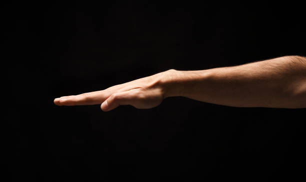 istock Strong male hand on black isolated background 912016232