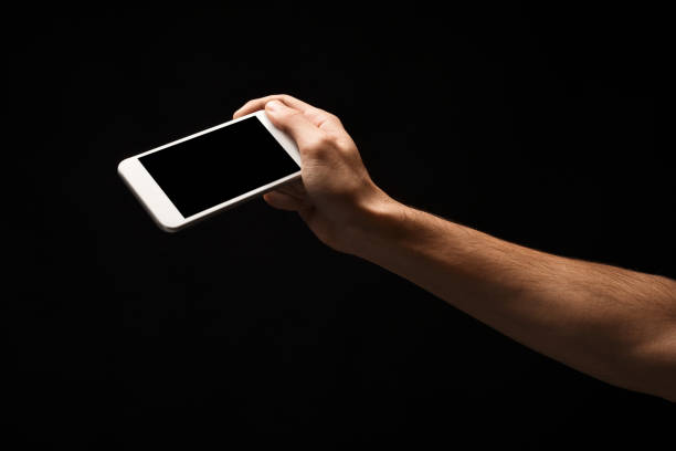 istock Male hand holding mobile smartphone with blank screen 912016308