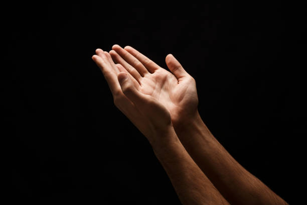 istock Man keeping hands in cupped shape, cutout on black 912016360