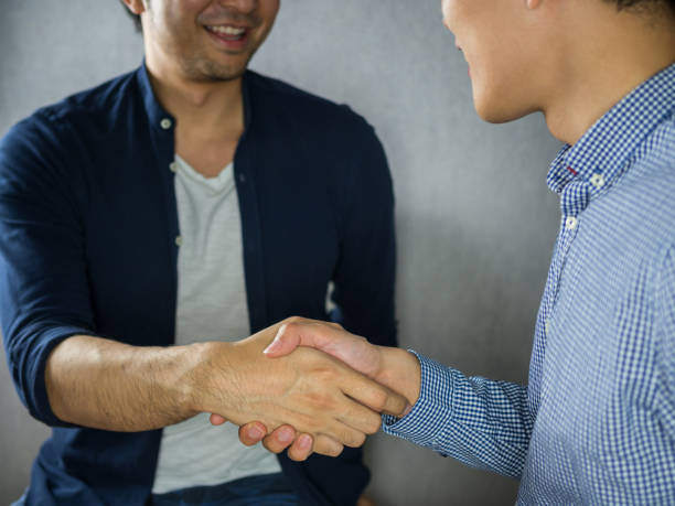 istock Two men making a handshake and looks happy 912016384