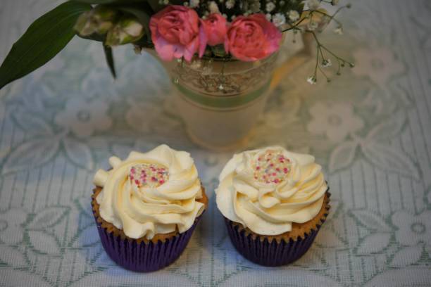 istock cupcakes on a vintage lace table cloth with fresh flowers 912018506