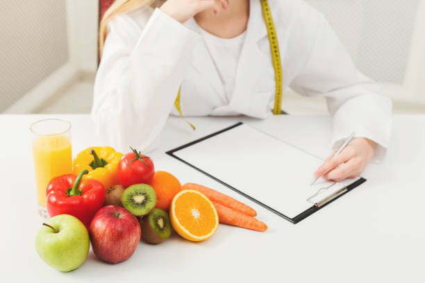 istock Nutritionist desk with fruit and measuring tape 912018906