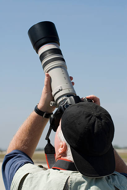 istock Photographer with telephoto lens 91202139