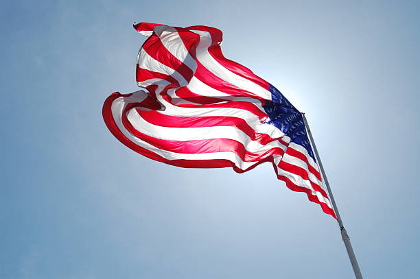 American Flag in front of the sun 5 stock photo