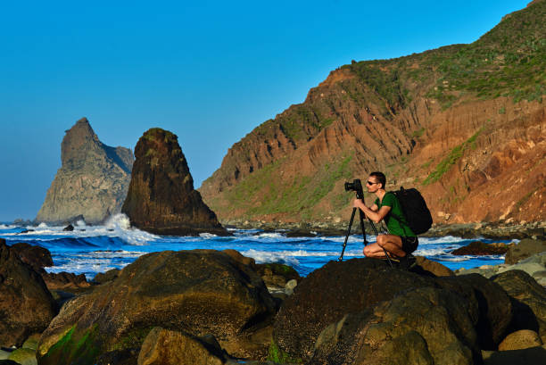 istock photographer on the coastline 912027564