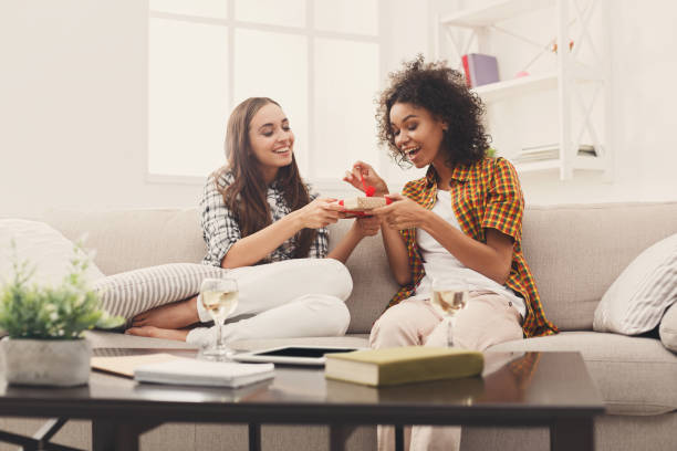 Excited woman getting gift from her girlfiend Happy girls exchanging gifts. Excited woman getting present from her friend. Birthday, holidays, celebration and female friendship concept, copy space gift for girlfriend stock pictures, royalty-free photos & images