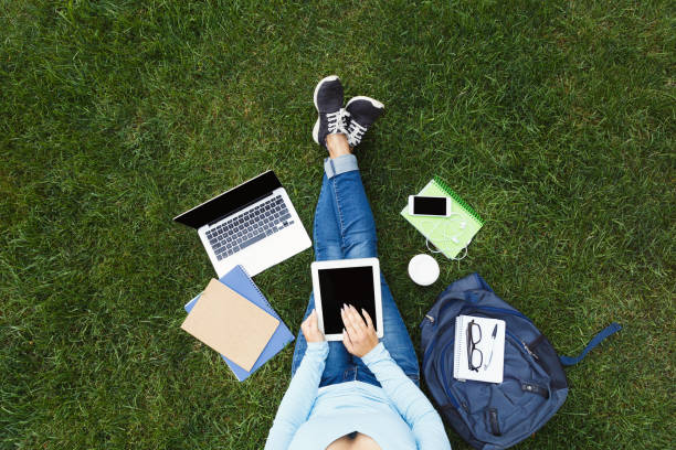 istock Girl with digital tablet on the grass 912030798