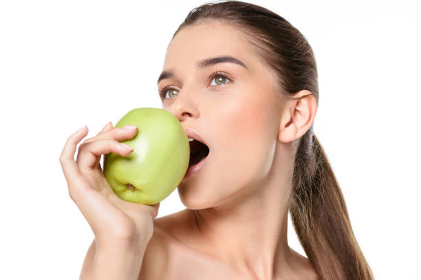 istock Young woman with apple 912031158
