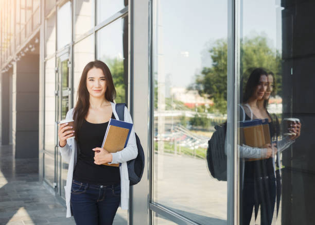 istock Beautiful student girl with textbooks and coffee 912035624