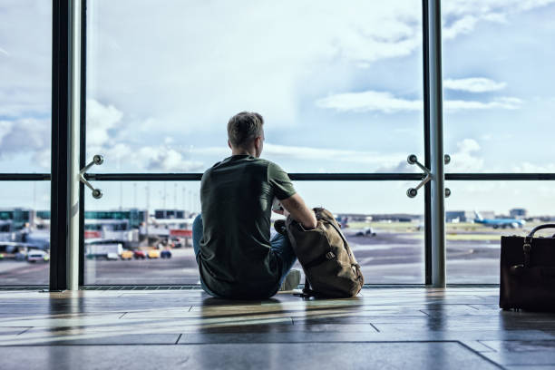 istock Man sitting in airport 912037516