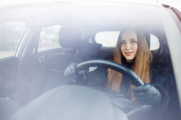 istock Young woman drive a car in winter 912038414