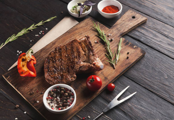 istock Grilled meat and vegetables on rustic wooden table 912045780