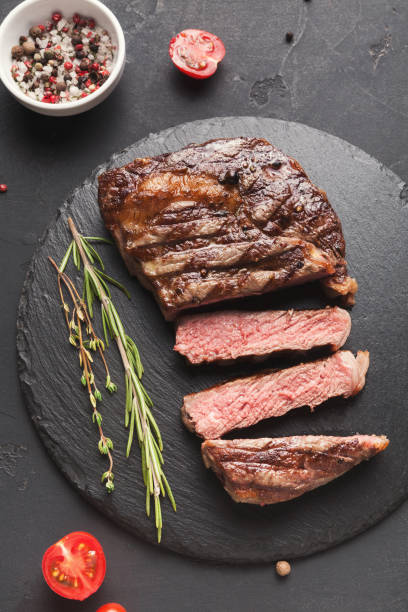 istock Rib eye steak and spices on black background 912046130