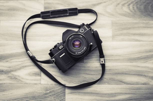 istock old camera with a flash installed in the middle of a brown wooden background 912046196