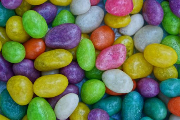 istock colored background of a pile of small chocolates 912054404
