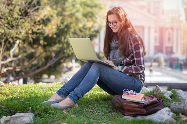 istock Young adult student studying in the park 912062720