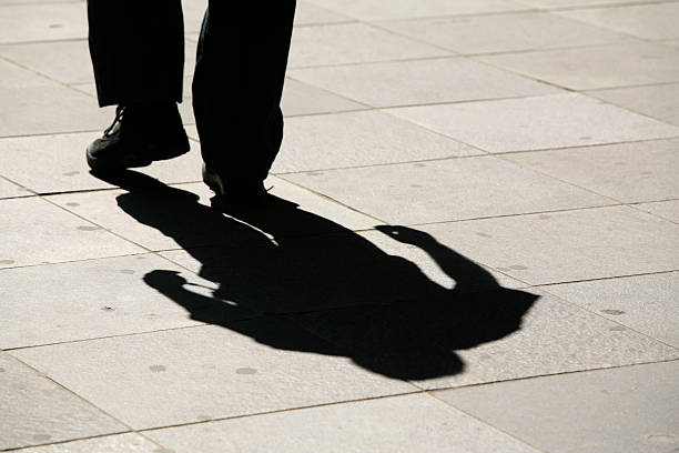 istock shadow of a walking man on his way to ... 91206686