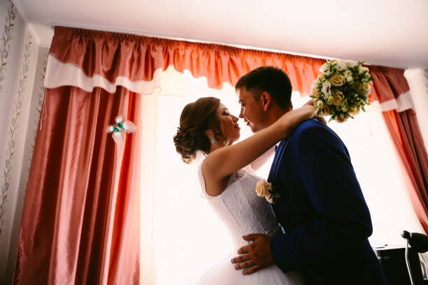 istock couple groom and bride hugging and kissing on light background 912066862