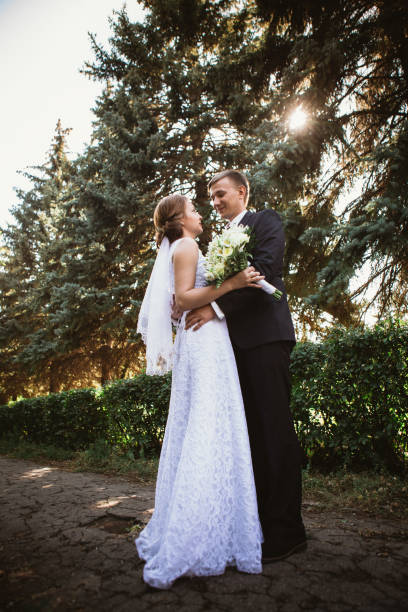 istock couple bride and groom on a park background 912069654