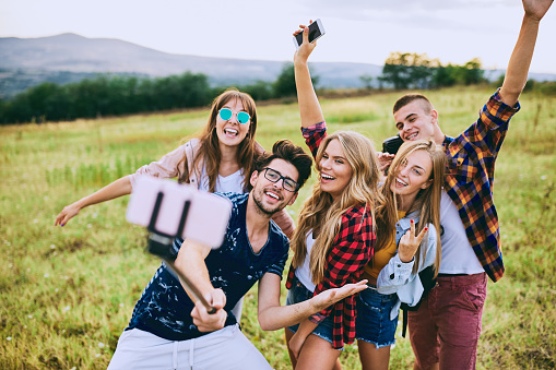 Group of teenagers posing for photo messaging.