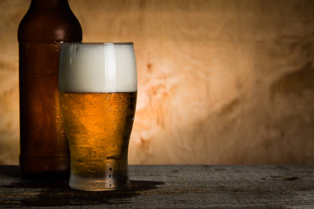 istock Beer in bottle and glass with ice drops 912071998