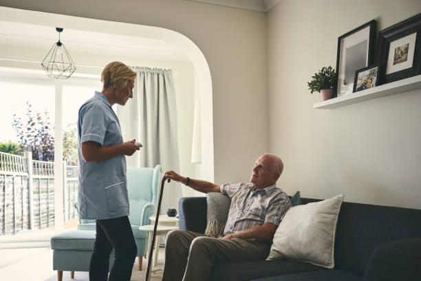 istock Retired man talking with home caregiver 912072042