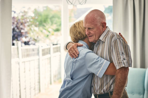 istock Female nurse hugging retired man 912072068