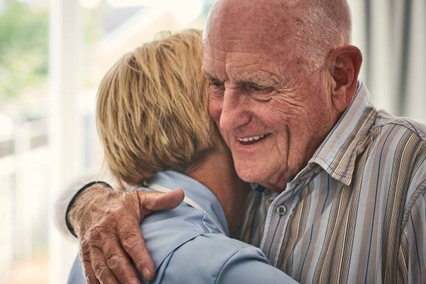istock Home carer hugging senior male patient 912072072