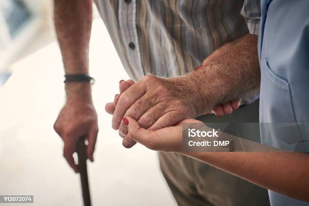 Female Nurse Supporting Senior Man To Walk Stock Photo - Download Image Now - Senior Adult, Nursing Home, Care