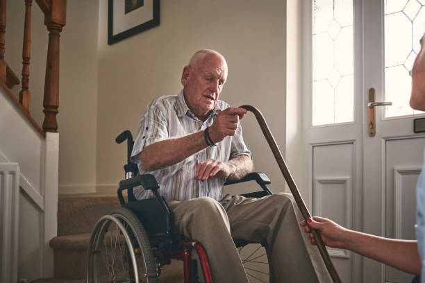 istock Disabled senior man at care home with nurse 912072100