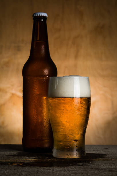 istock Beer in bottle and glass with ice drops 912072122