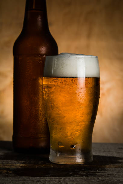 istock Beer in bottle and glass with ice drops 912072174
